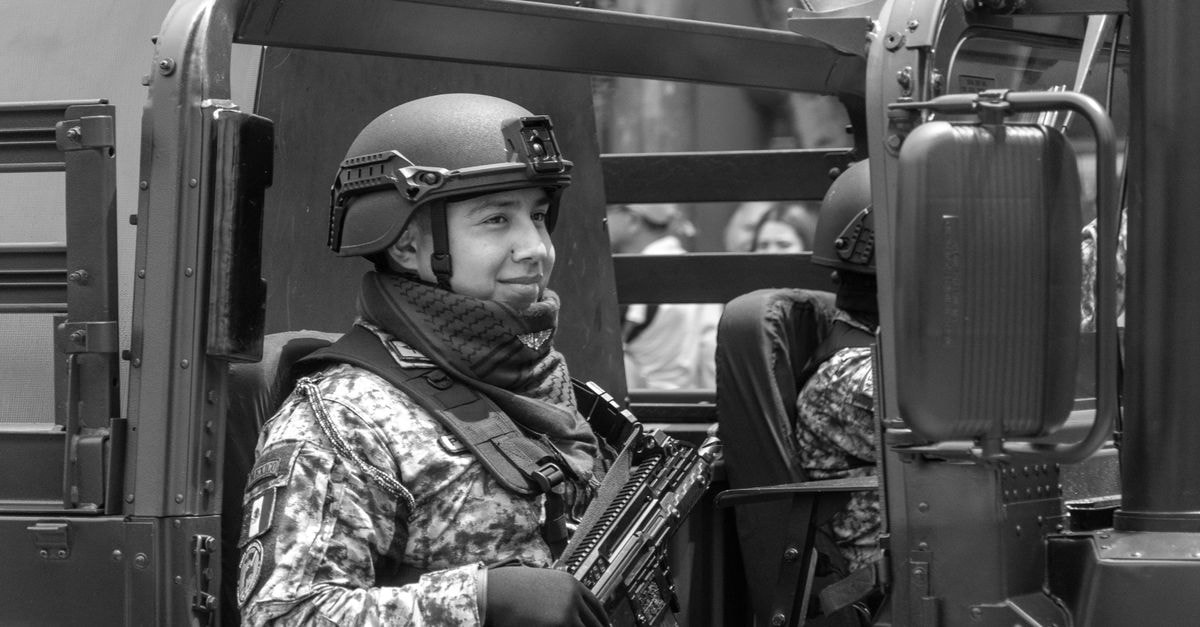 Mexican military officer in an armored vehicle during a Mexico City parade, showcasing national pride.
