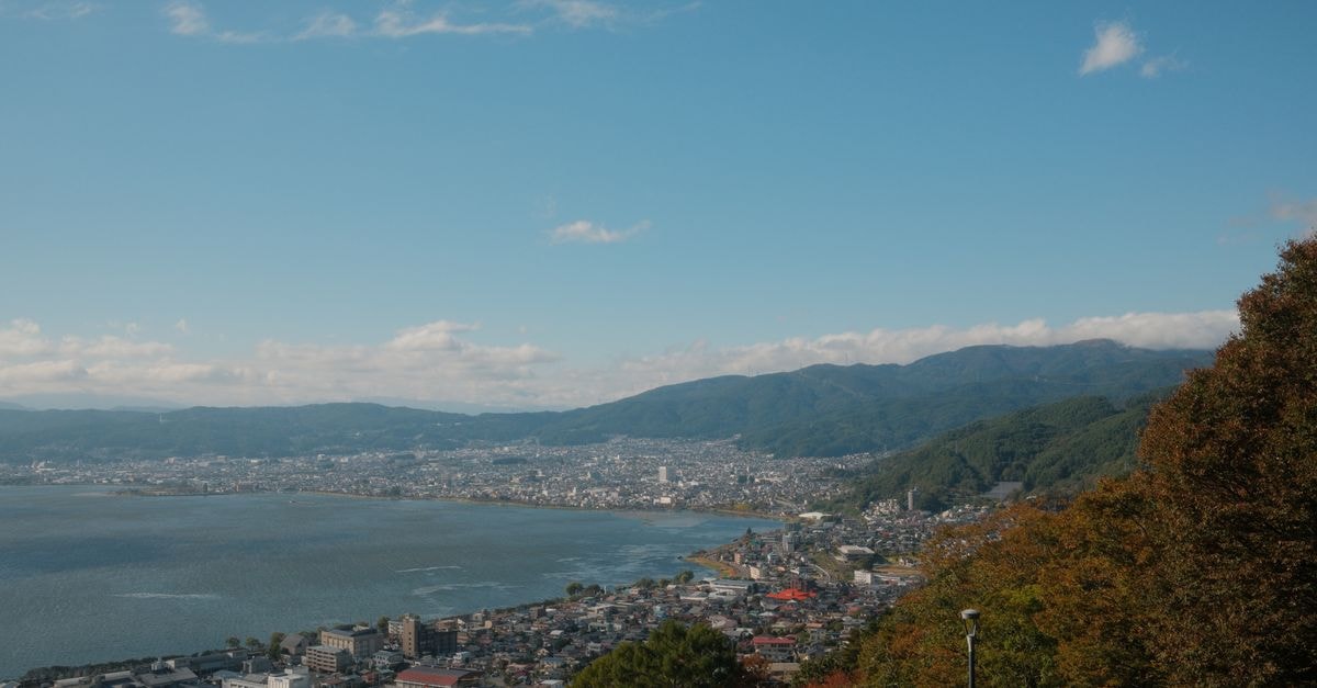 OMO5小樽, Otaru — A City Hotel in the Ironai District Stunning aerial view of Suwa City in Nagano, Japan, featuring a serene lake and distant mountains.