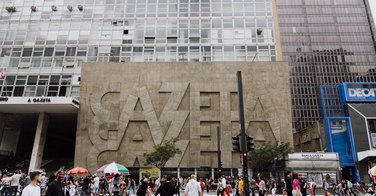 Crowded street view in front of Gazeta building on Paulista Avenue, São Paulo.