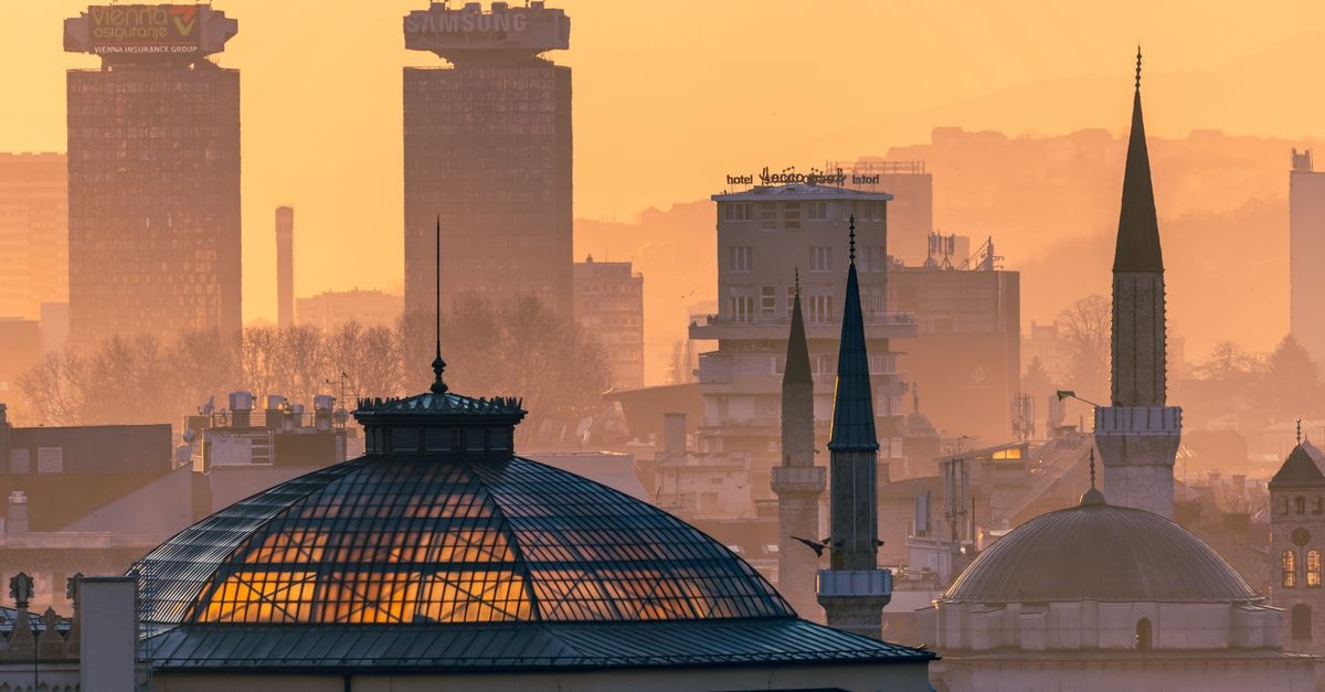 Golden hour view of Sarajevo skyline with notable landmarks in evening light.