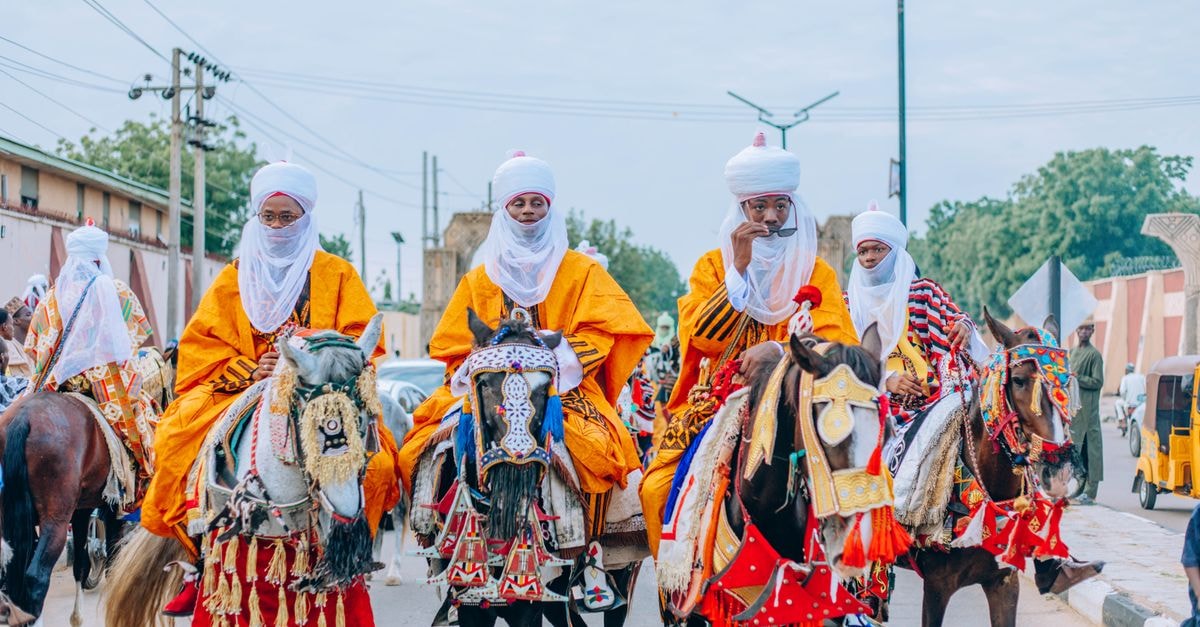 Maroua Travel Guide: Quiet Corners of Cameroon's Vibrant display of traditional attire and horses at a Nigerian festival parade.
