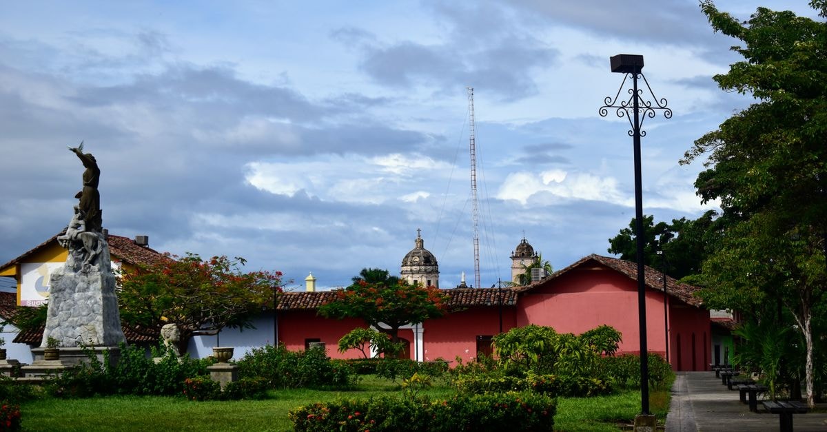 A Quiet Corner of Nicaragua: Ocotal Travel Guide Colonial architecture and statue in a scenic town square on a cloudy day.