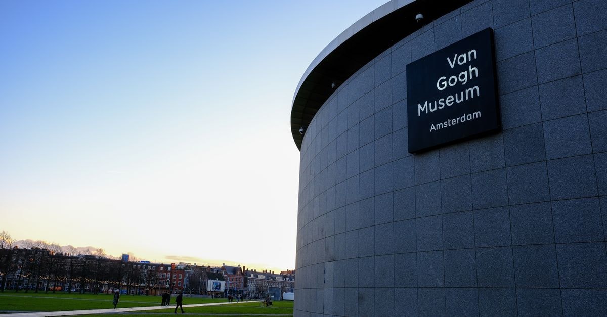 Van Gogh Hotel in Kyzylorda: Quiet Comfort on Bahadura Street Exterior view of Van Gogh Museum in Amsterdam with blue sky and green park.