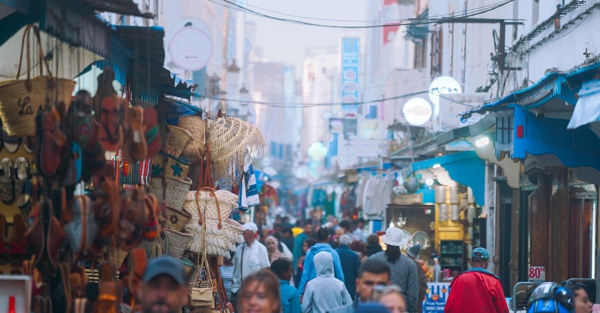 Safi Travel Guide: Planning Tips, Costs and Things to Do Bustling street market in Essaouira Medina with vendors and shoppers, reflecting Moroccan culture.