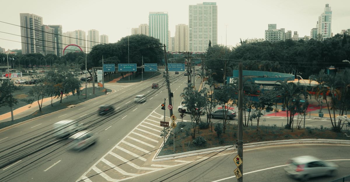 Cityscape of São Bernardo do Campo, Brazil, featuring a busy intersection with skyscrapers and blurred vehicles.