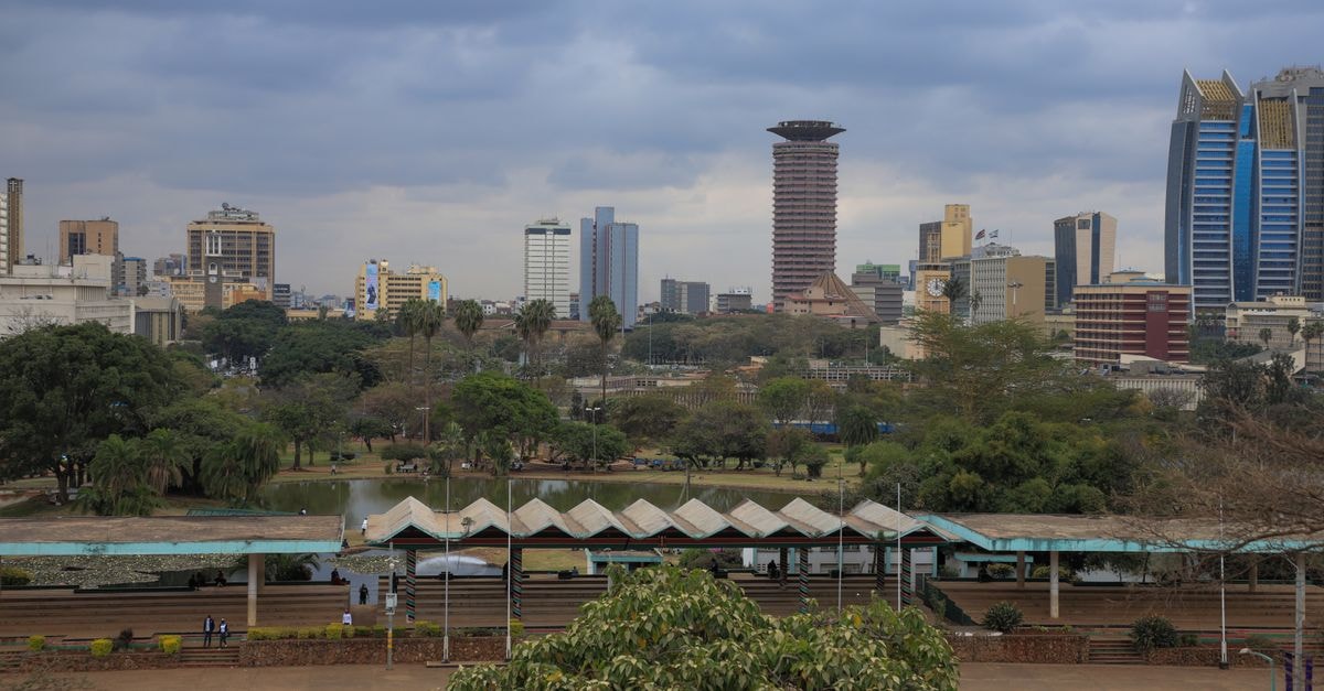 Nairobi Travel Guide: How to Plan a Confident City Visit Nairobi cityscape featuring modern skyscrapers and lush greenery on a cloudy day.