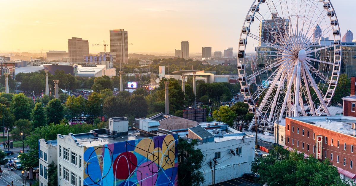 Atlanta Marriott Marquis in Downtown Atlanta: A 50-Story Stay Near the City’s Icons Aerial view of Atlanta skyline with SkyView Ferris Wheel at sunset.