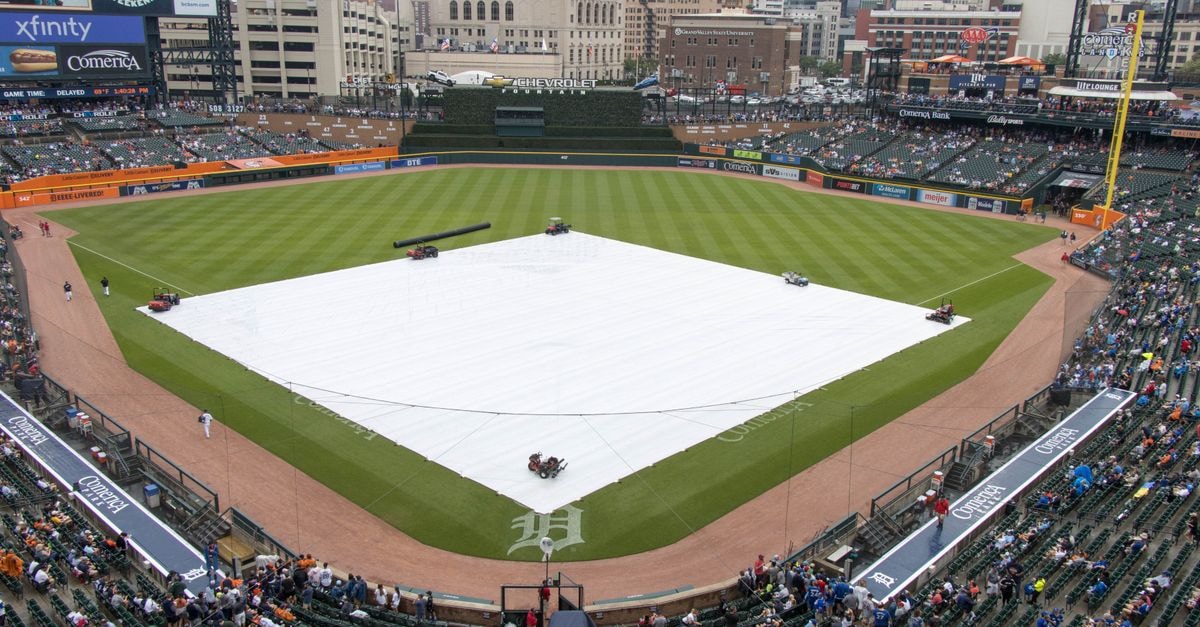 Aerial view of Comerica Park in Detroit with the baseball field covered, surrounded by the city skyline.