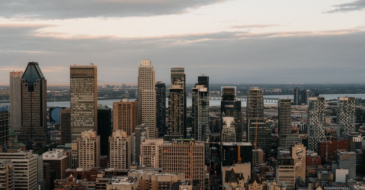 Aerial view of Montreal's downtown skyscrapers at dusk, showcasing a blend of modern architecture.