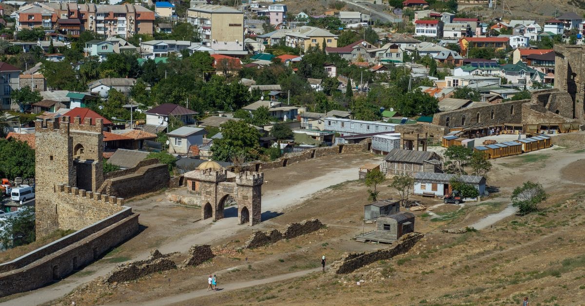 Minya Travel Guide: Planning Tips, Costs and Things to Do Aerial view of a historic village with ancient fortifications and diverse architecture.