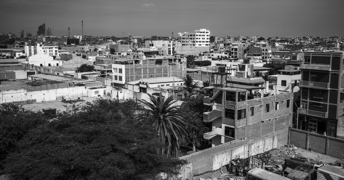 Sharif Hotel in Chiniot: A Welcoming Stop on Jhang-Chiniot Road Aerial view of urban cityscape in black and white showcasing dense residential buildings.