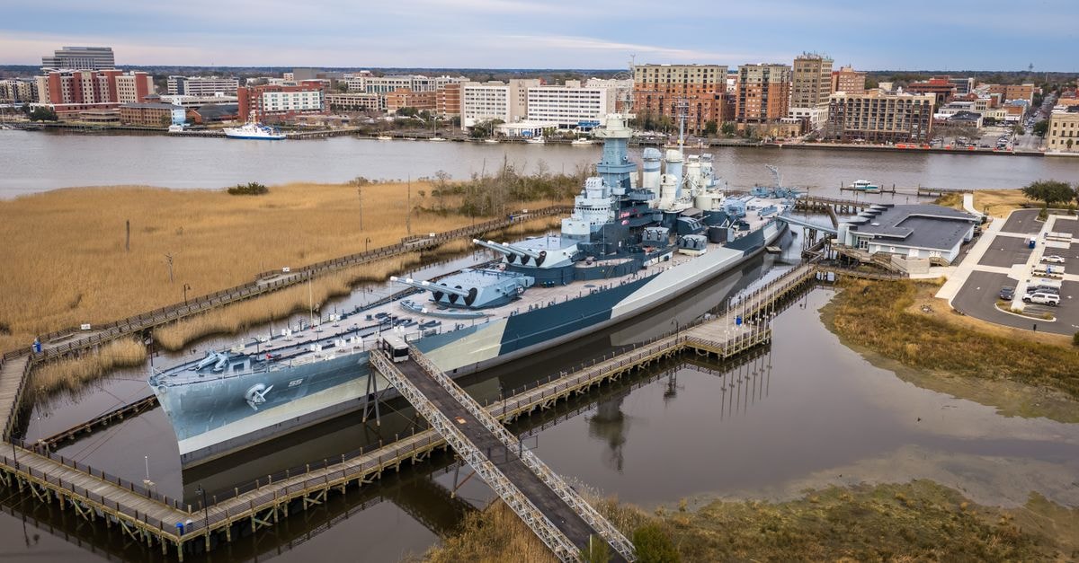 Columbia, South Carolina Travel Guide: Rivers, History, and Local Pace Aerial view of the USS North Carolina in Wilmington, NC with cityscape.