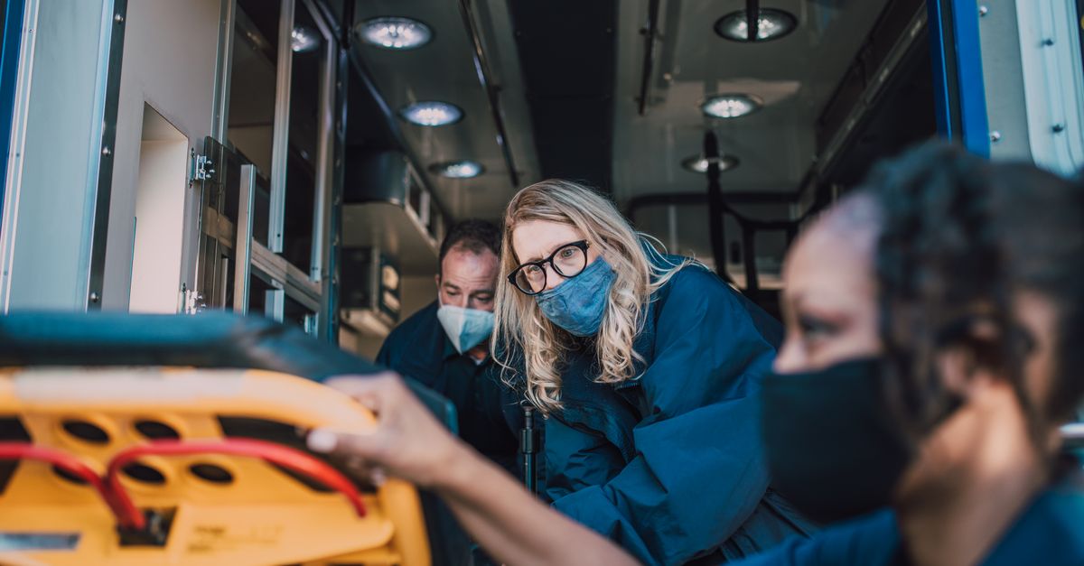 Paramedics attending to a patient inside an ambulance, ensuring immediate care.