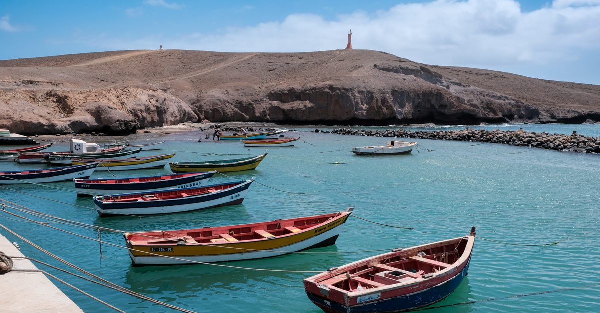 Bahía Blanca Travel Guide: Planning Tips, Costs and Things to Do Lively scene of colorful fishing boats anchored in the serene waters of Pedra Lume, Sal, Cabo Verde.