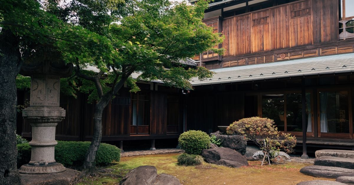 Authentic Japanese wooden house surrounded by a tranquil garden in Tokyo.