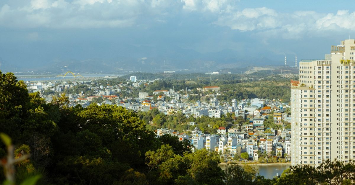 Sir Milton Hotel in Bo: A Welcoming Stop on Kissy Town Road Aerial view of a vibrant city in Vietnam with high-rise buildings and lush greenery.