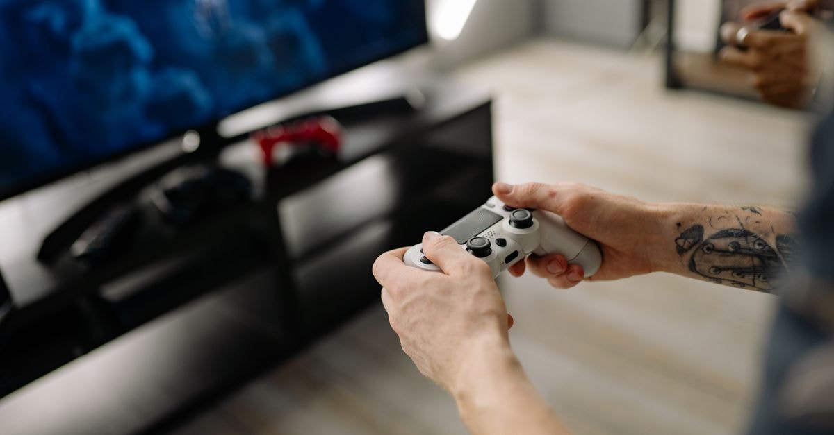 US Nintendo Switch 2 Game-Key Card spending jumps 631% year-to-date, driving 5% rise in new physical software sales Person playing video games using a game controller indoors on a modern TV setup.