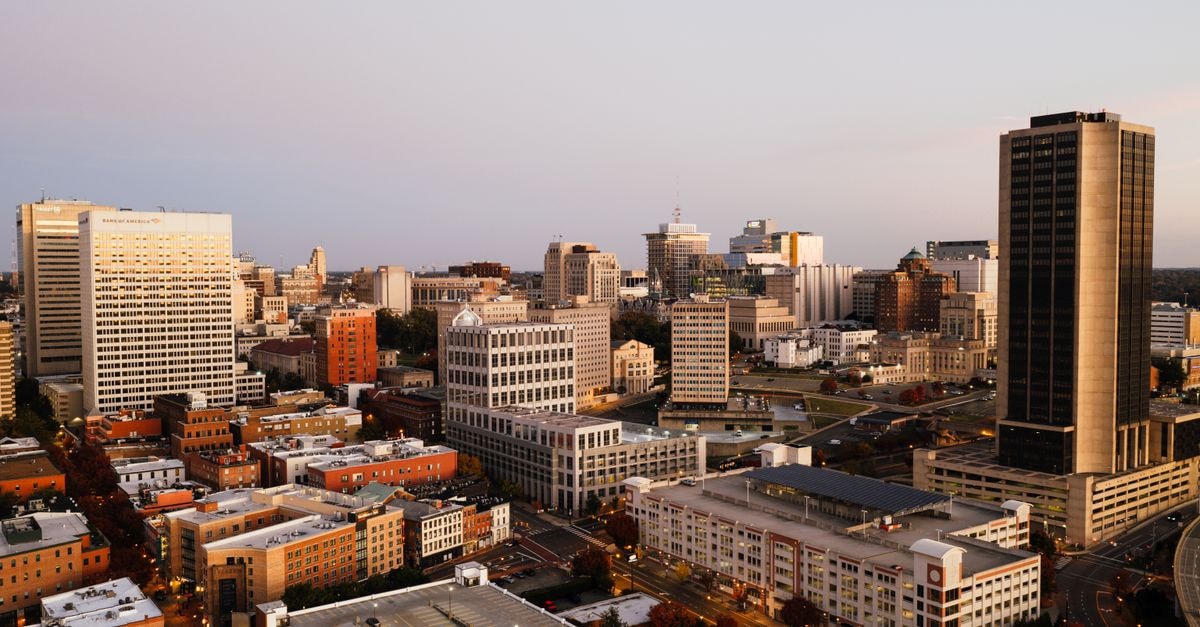 Greensboro Travel Guide: How to Eat, Explore and Get Around Captivating aerial view of Richmond's downtown skyline during golden hour.