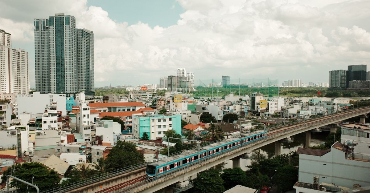 Kekeli Hotel in Ho: A Church-Run Stay Near Denu Road Aerial view of a modern metro train in the vibrant cityscape of Ho Chi Minh City, Vietnam.