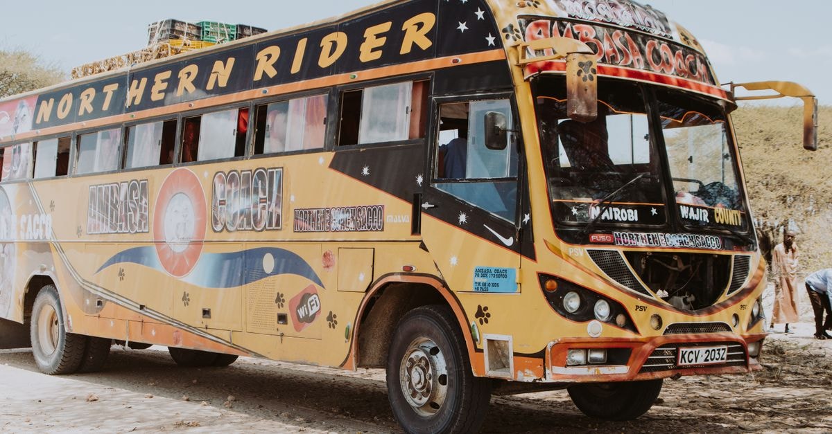 Wajir Guest House, Wajir: Spacious Rooms on Wajir-Moyale Road A vibrant Northern Rider bus parked on a dusty road in rural Kenya, showcasing local travel culture.