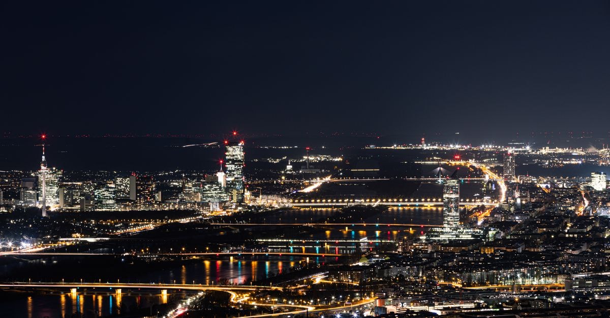 Palais Hotel Pertschy, Vienna — A Baroque Townhouse Retreat 400m from St. Stephen's Stunning nighttime view of Vienna, Austria with illuminated cityscape and Danube River reflections.