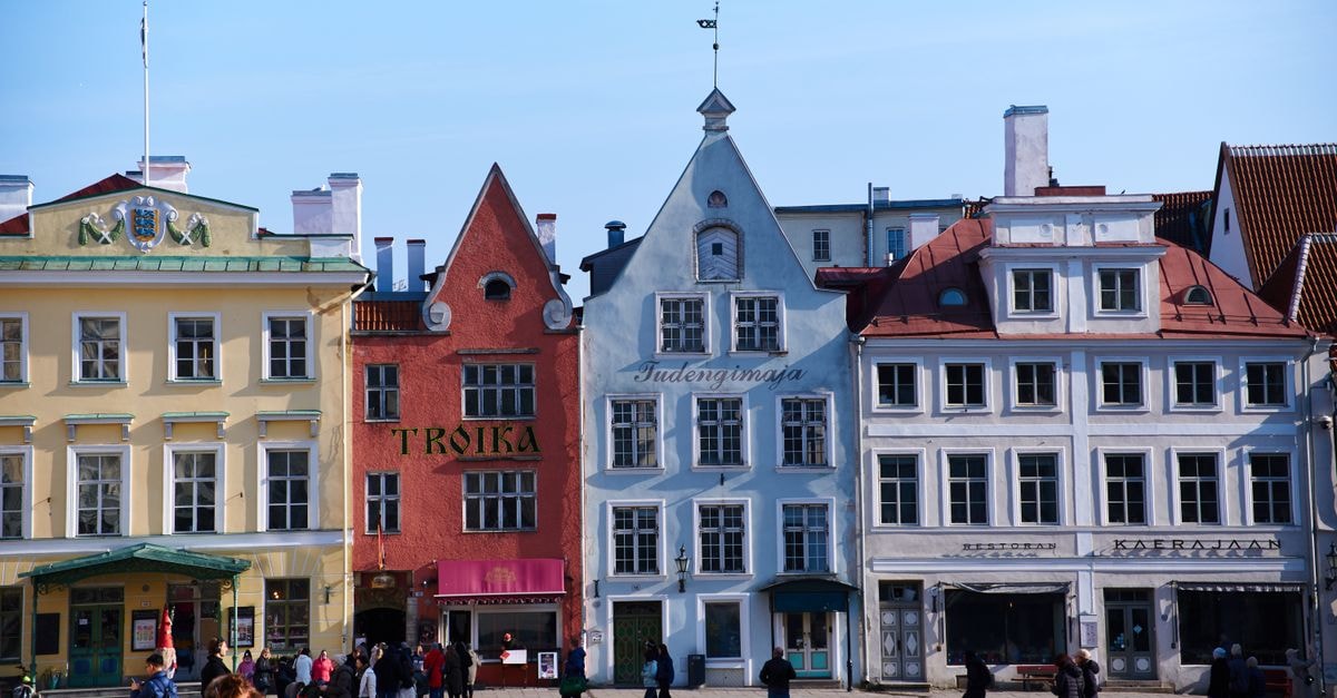 Marijampolė Travel Guide: A Quiet Baltic City Worth Slowing Down For Picturesque view of colorful historic buildings in Tallinn's Old Town square.