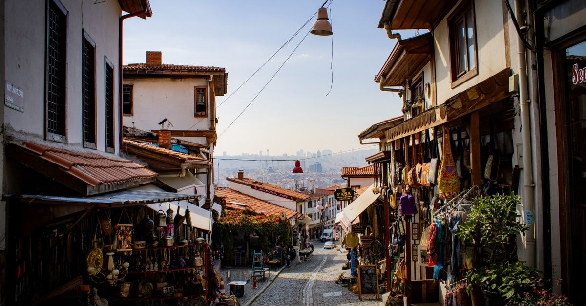 Explore a picturesque old bazaar street in Ankara, Türkiye, showcasing traditional architecture and market stalls.