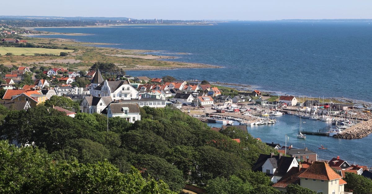 Mariehamn Travel Guide: Planning Tips, Costs and Things to Do A picturesque view of Mölle's harbor and coastal town in Sweden with lush greenery and clear blue sea.