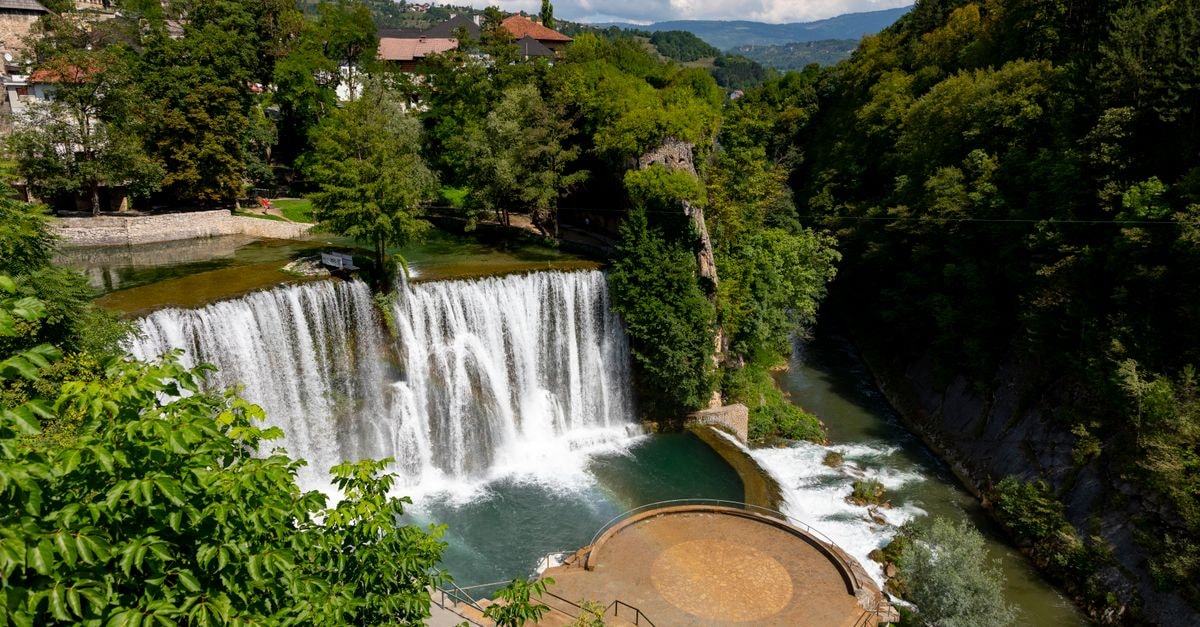 Pljevlja Travel Guide: Planning Tips, Costs and Things to Do Scenic view of Pliva Waterfall surrounded by lush greenery in Jajce, Bosnia and Herzegovina.