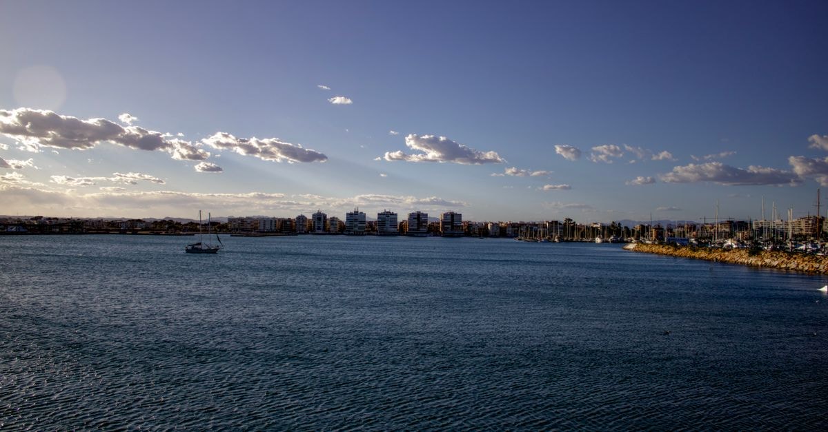 Land Plaza in Bahía Blanca — A Central Stay on Saavedra 41 Beautiful coastal scene of Torrevieja, Spain during the day, featuring calm waters and a clear sky.