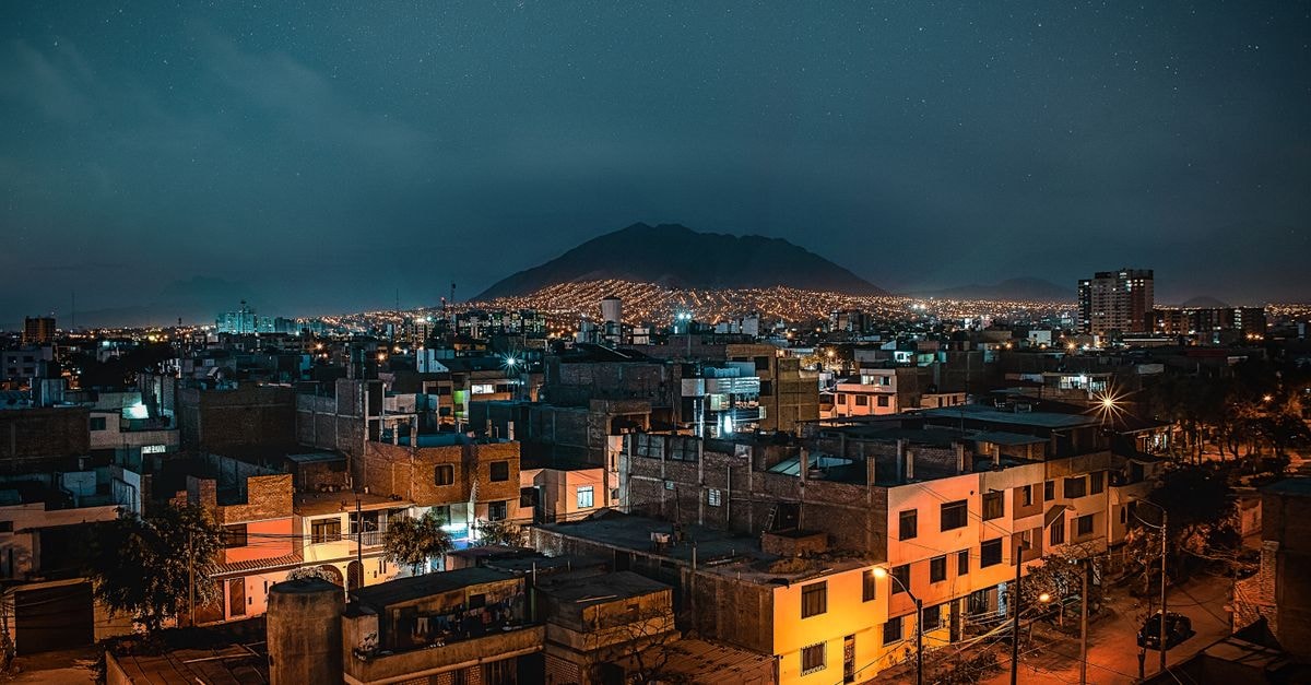 A captivating night view of Trujillo, Peru, featuring a vivid cityscape under a starry sky.