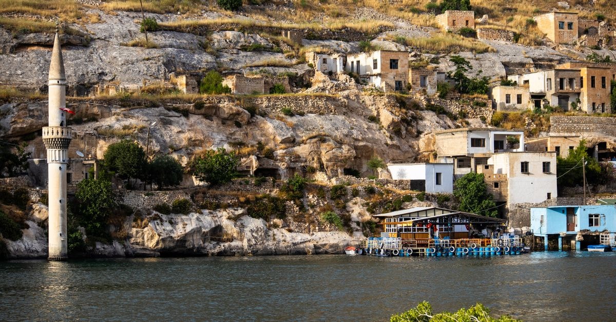 Umraniye Travel Guide: Planning Tips, Costs and Things to Do Explore the charming architecture of Halfeti's sunken city featuring a prominent minaret by the river.