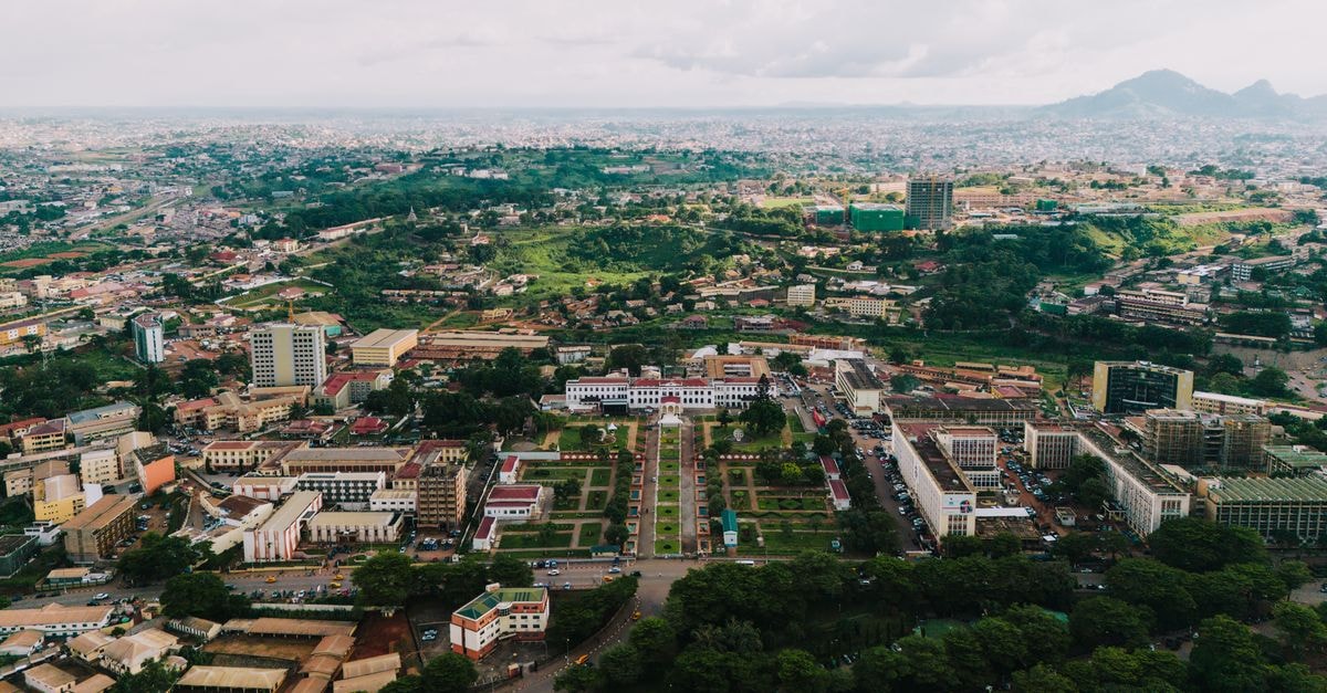 Protea Hotel Benin City Select Emotan: Modern Comfort on Central Road Stunning aerial view of Yaoundé cityscape with green landscapes and urban architecture.