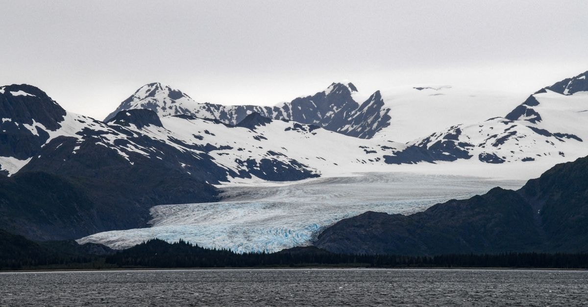 Juneau, Alaska travel guide: gold rush roots and a one-of-a-kind food scene A breathtaking view of a glacier surrounded by snow-capped mountains in Alaska's Prince William Sound.