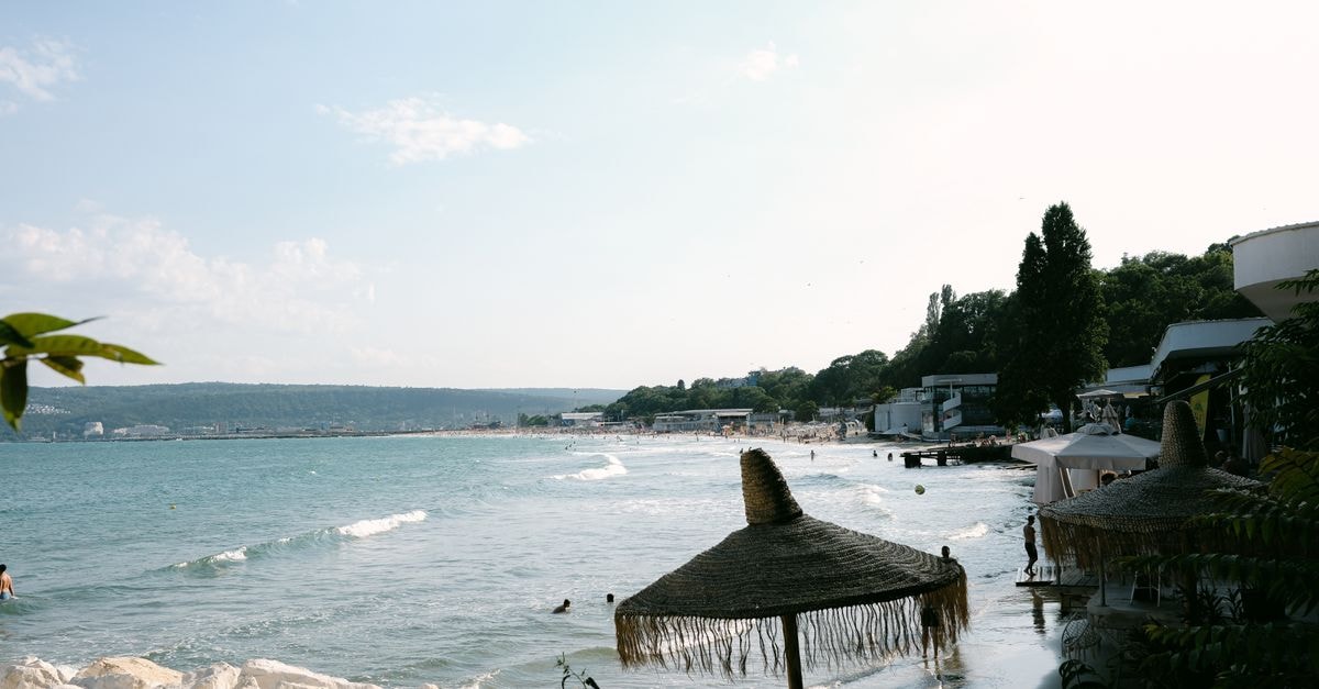 Burgas Travel Guide: Beaches, Markets, and Bulgarian Flavors A tranquil beach scene in Bulgaria with umbrellas and clear waters, perfect for holiday relaxation.