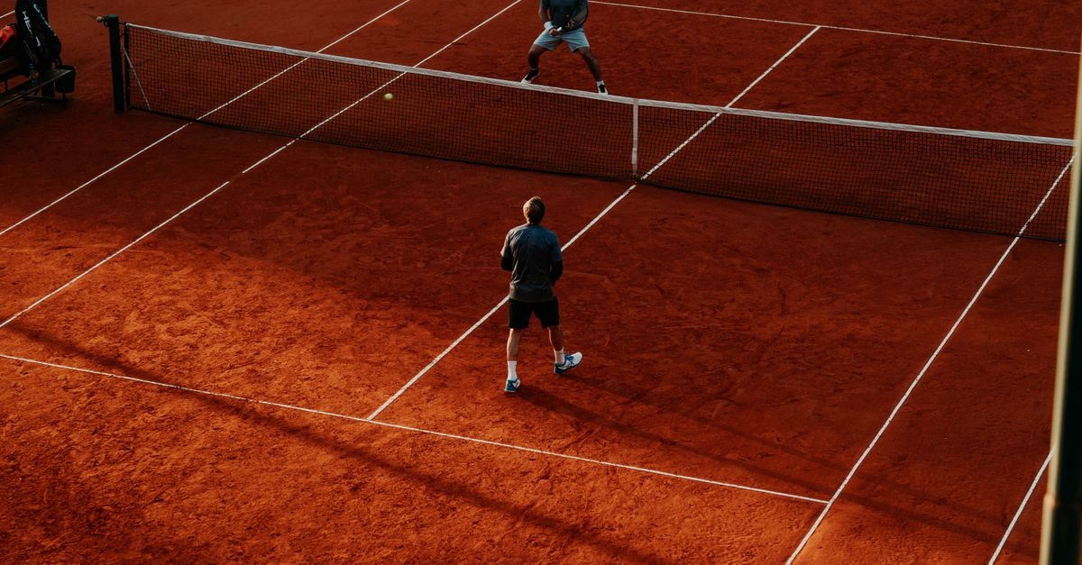 Intense tennis match on a vibrant clay court, capturing the competitive spirit.