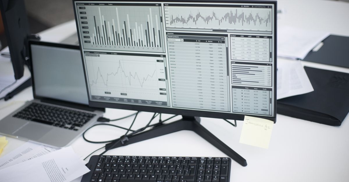 Salesforce set to acquire AI analytics platform Loops A professional workspace featuring computers and analytical graphs on a monitor, symbolizing modern business environment.