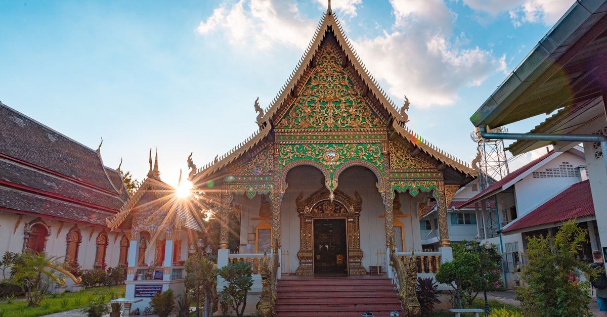 Beautiful ornate temple facade with sunburst at Wat Chiang Man, showcasing traditional Thai architecture.