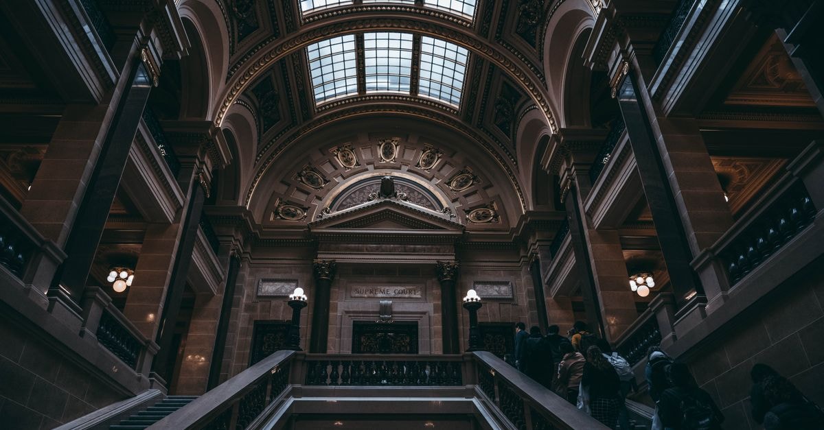 A Slow Travel Guide to Madison, Wisconsin Elegant baroque architecture inside Wisconsin State Capitol, Madison, showcasing grand staircases and intricate details.