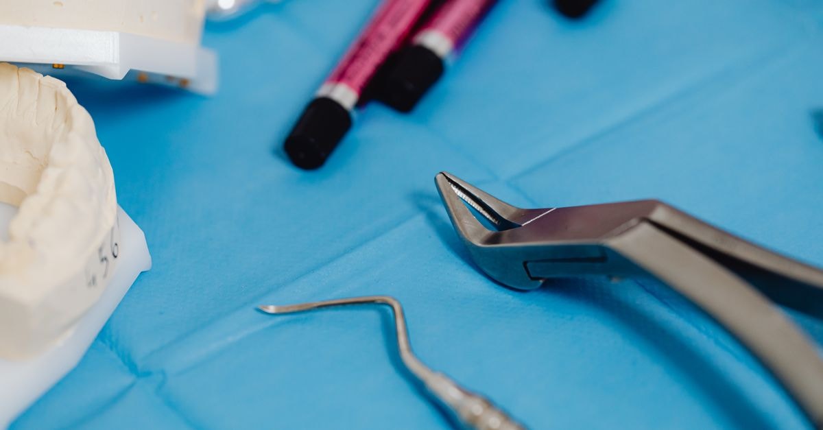 UFP Technologies: Premium-Quality Medical Contract Manufacturer Trading at a Steep Multiple Detailed view of dental equipment and models on a sterile blue background in a healthcare setting.