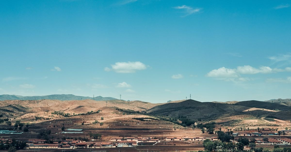 Hohhot Travel Guide: Getting Around and Eating Well in Inner Mongolia's Capital A picturesque view of rolling hills and blue sky in Hohhot, Inner Mongolia, China.
