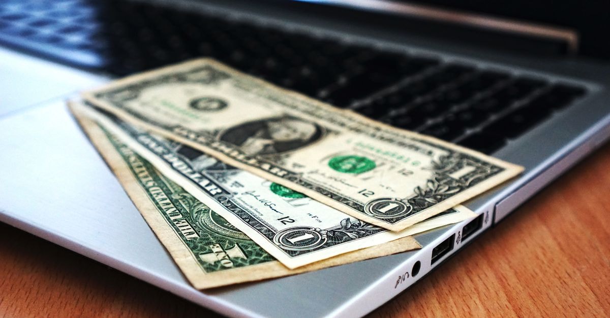 DoorDash runs 15%-off first-order promo for new users through Sept. 30 Close-up of US dollar bills placed on a laptop symbolizing digital finance and economy.