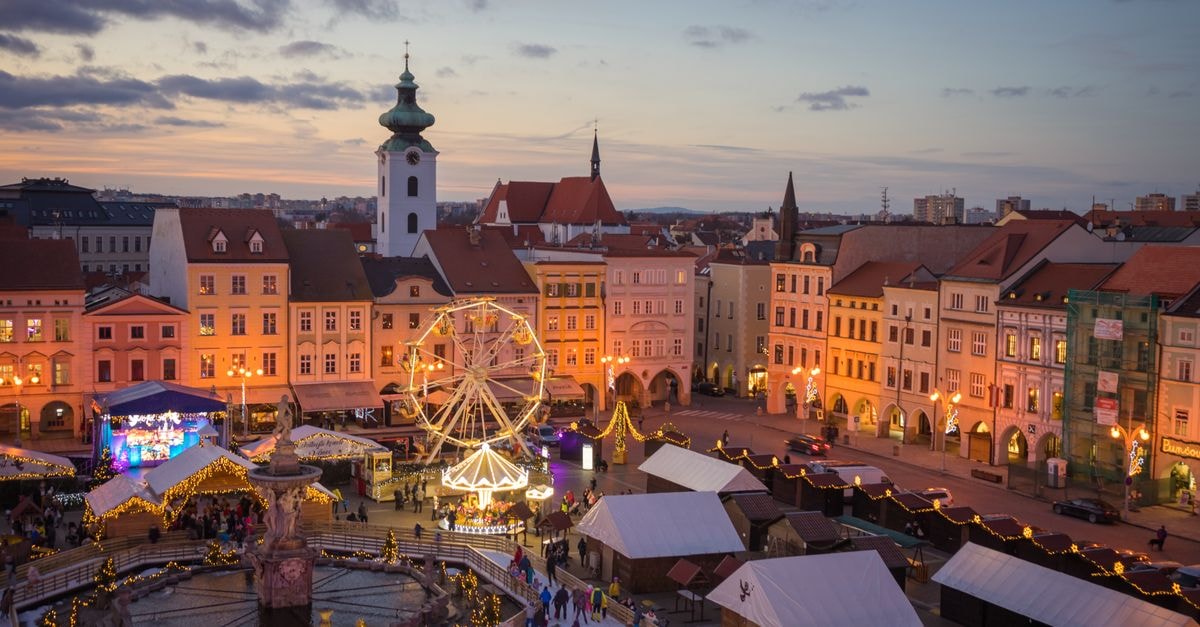 Enchanting view of České Budějovice's festive Christmas market lit up at twilight.