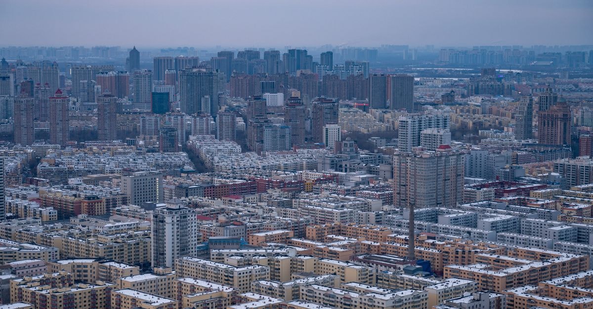 Phoenix Hotel in Hohhot: A 2000-Era City Center Stay Near Government and Finance Hubs Expansive view of Harbin city skyline under a winter sky, showcasing dense urban architecture.