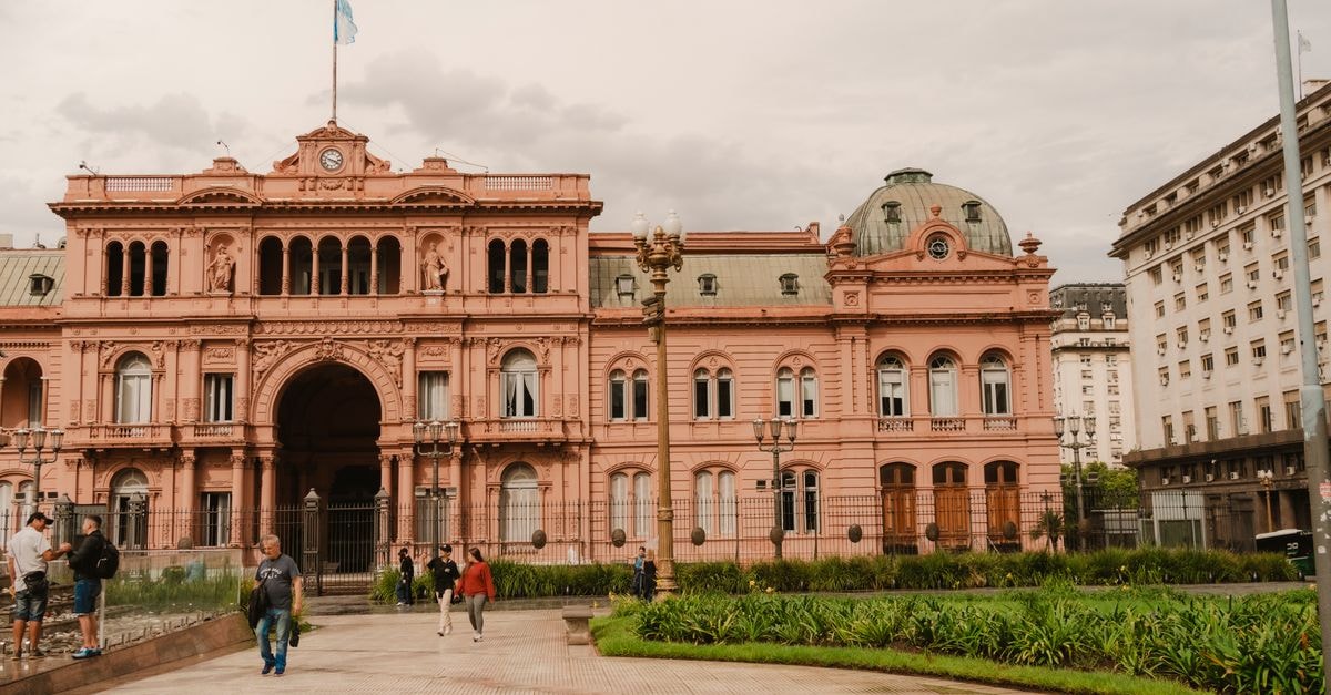 San Jose de Mayo Travel Guide: Planning Tips, Costs and Things to Do Front view of the historic Casa Rosada in Buenos Aires, Argentina with people in foreground.