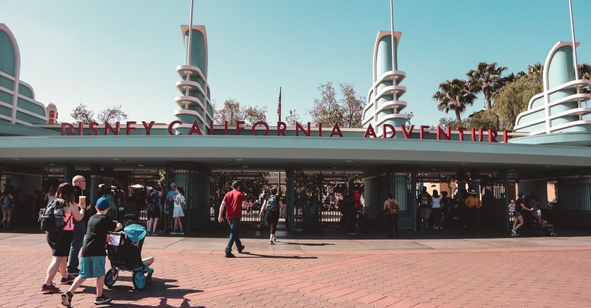 Visitors at Disney California Adventure Park entrance in Anaheim, a popular family destination.
