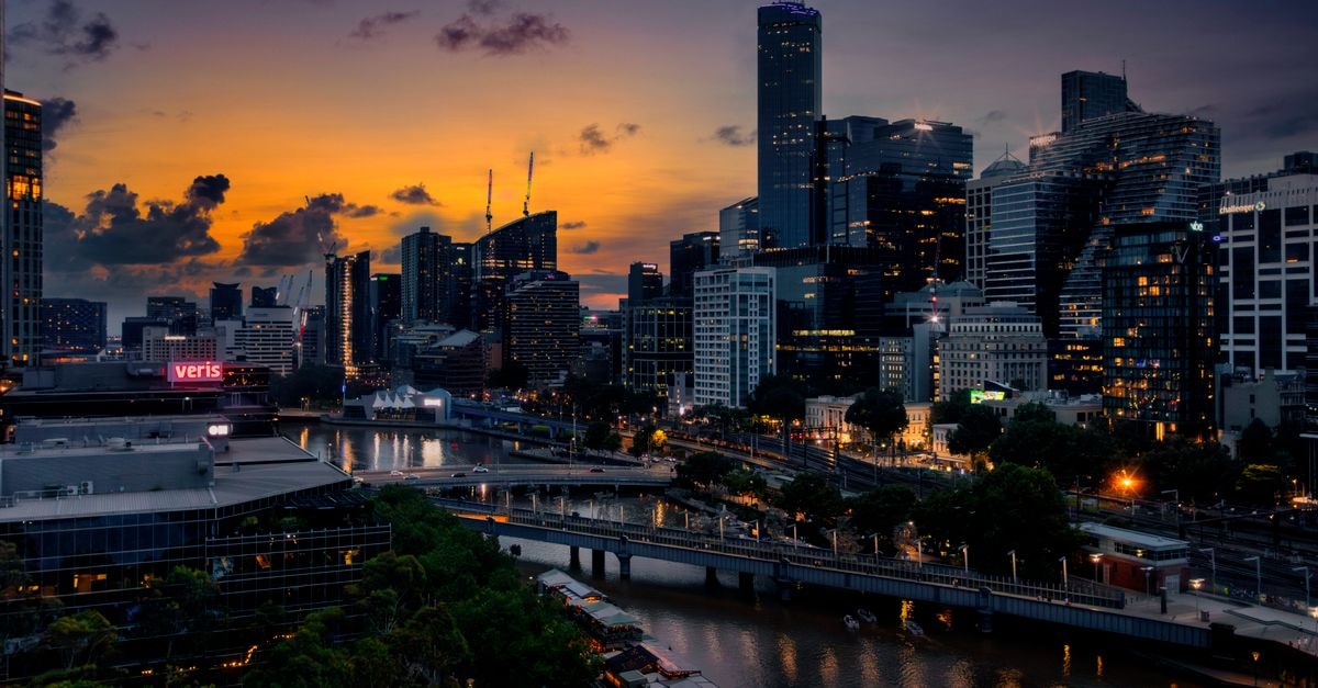 Stunning view of Melbourne's illuminated skyline during a vivid sunset.
