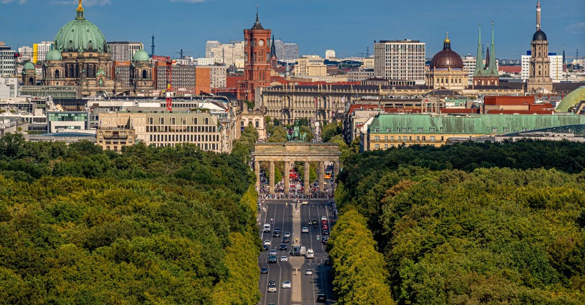 Maritim proArte Hotel Berlin, Berlin — Designer Stay on Friedrichstrasse A beautiful aerial view of Berlin featuring the iconic Brandenburg Gate and the Berliner Dom during a sunny day.