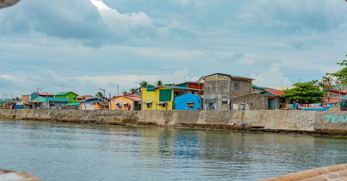 Ciudad Victoria Travel Guide: Planning Tips, Costs and Things to Do Vibrant fishing village with colorful houses along a serene waterfront.