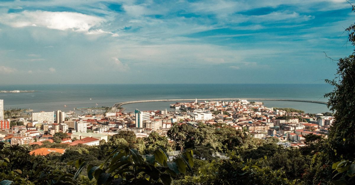The Unfinished Hotel on the Outskirts of Maldonado: A Mystery Monument A stunning aerial view of a coastal city overlooking the vast ocean under a clear blue sky.